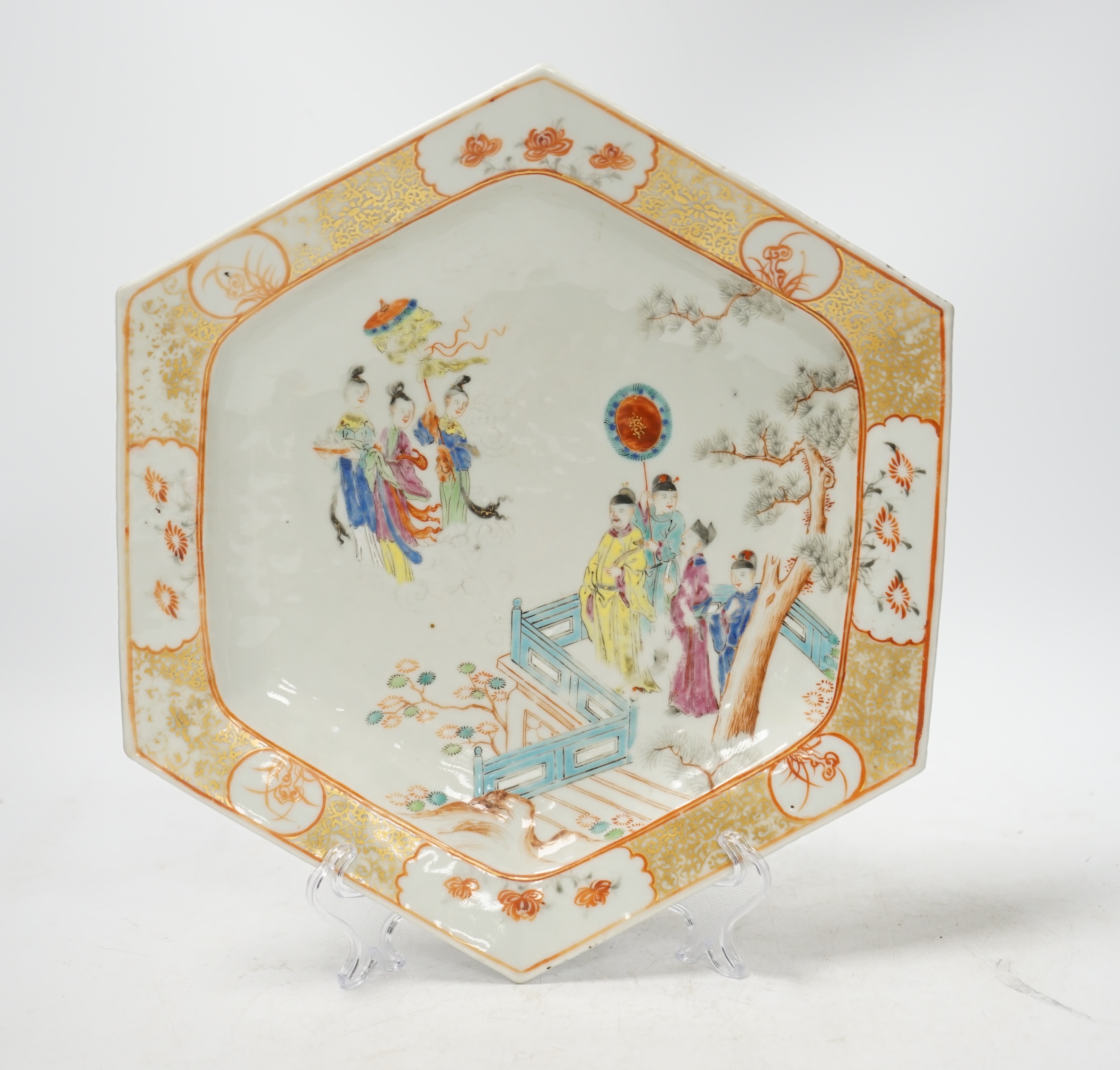 An 18th century Chinese hexagonal dish, painted with figures on a terrace, 28cm wide. Condition - fair, feint star crack to base